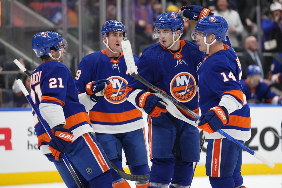 New York Islanders' Bo Horvat (14) celebrates with Noah Dobson (8), Brock Nelson (29) and Kyle Palmieri (21) after scoring a goal against the Toronto Maple Leafs during the second period of an NHL hockey game Thursday, Jan. 11, 2024, in Elmont, N.Y. (AP Photo/Frank Franklin II)