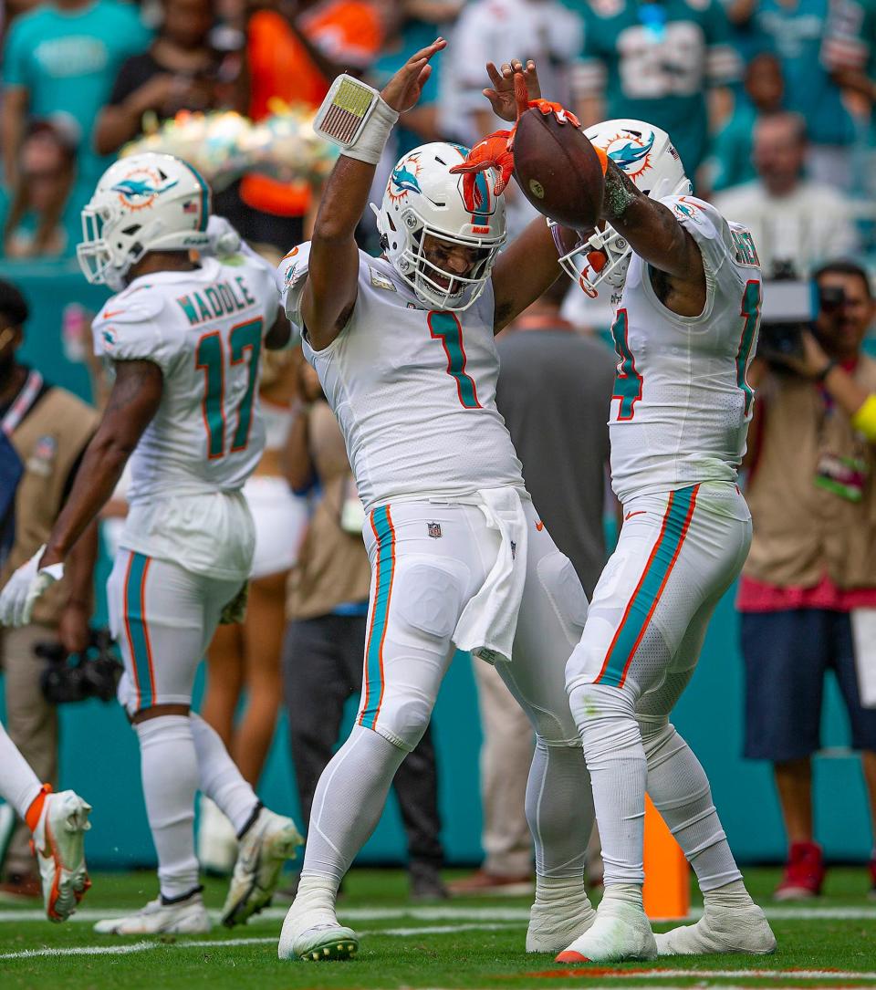 Miami Dolphins quarterback Tua Tagovailoa (1) and Miami Dolphins wide receiver Trent Sherfield (14), celebrate after scoring a touchdown late in the first half agains the Cleveland Browns during NFL action Sunday November 13, 2022 at Hard Rock Stadium in Miami Gardens.