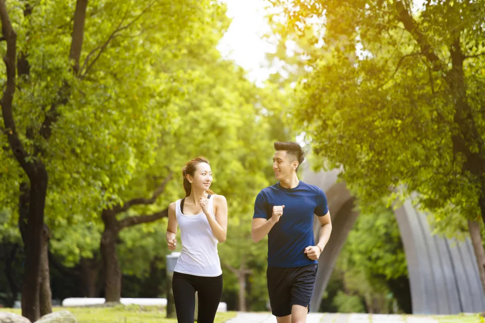 Happy young couple jogging in the park. Photo: iStock