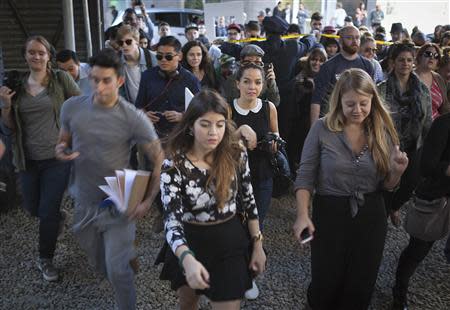 People rush to see a new art installation by British graffiti artist Banksy in New York October 18, 2013. REUTERS/Carlo Allegri