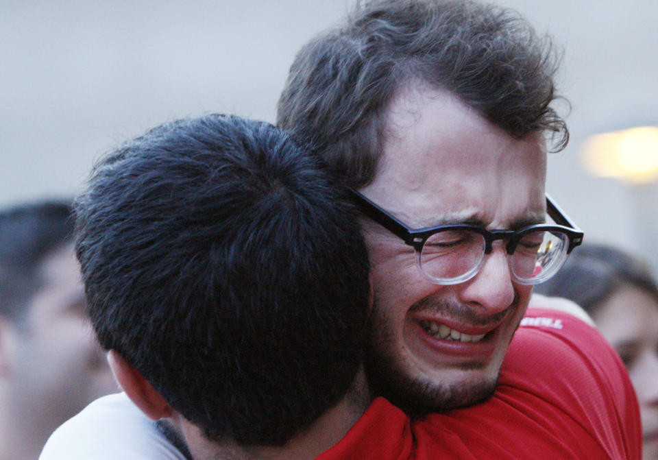 Boston University student Blake Wrobbel, of Los Angeles, right, becomes emotional during a candlelight vigil on Marsh Plaza at Boston University, Saturday, May 12, 2012, for three students studying in New Zealand who were killed when their minivan crashed during a weekend trip. Daniela Lekhno, 20, of Manalapan, N.J.; Austin Brashears, 21, of Huntington Beach, Calif.; and Roch Jauberty, 21, whose parents live in Paris, were killed as they traveled in a minivan on Saturday. (AP Photo/Bizuayehu Tesfaye)