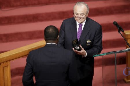 New York City Police Department Commisioner Commissioner William J. Bratton presents the new detective shield of slain New York City police (NYPD) Randolph Holder, who was posthumously promoted, to Holder's father during the funeral service in New York October 28, 2015. REUTERS/Mary Altaffer/Pool