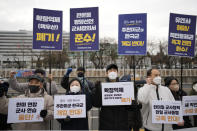 Protesters shout slogans during a rally outside of Defense Ministry, the venue for the meeting between U.S. Secretary of Defense Lloyd Austin and his South Korean counterpart Lee Jong-sup, in Seoul, South Korea, Tuesday, Jan. 31, 2023. A part of letters read "Stop the joint military exercise between the U.S. and South Korea." (AP Photo/Lee Jin-man)