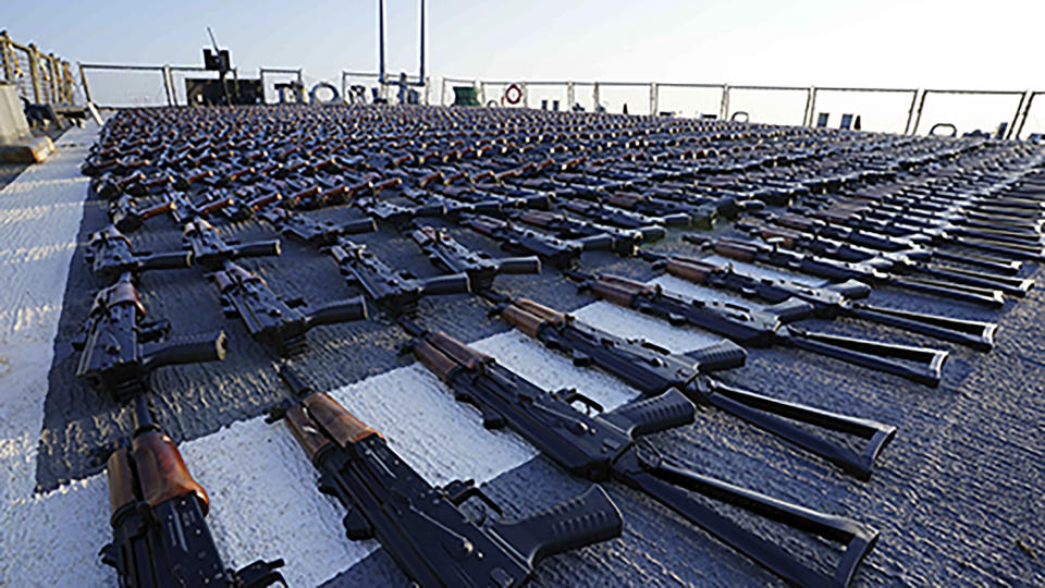 In this photo release by the U.S. Navy, hundreds of AK-47 assault rifles sit on the flight deck of the guided-missile destroyer USS The Sullivans during an inventory process, Jan. 7, 2023. The U.S. Navy has seized over 2,100 assault rifles from a ship in the Gulf of Oman it believes came from Iran and were bound for Yemen's Iran-backed Houthi rebels. (U.S. Navy photo via AP)