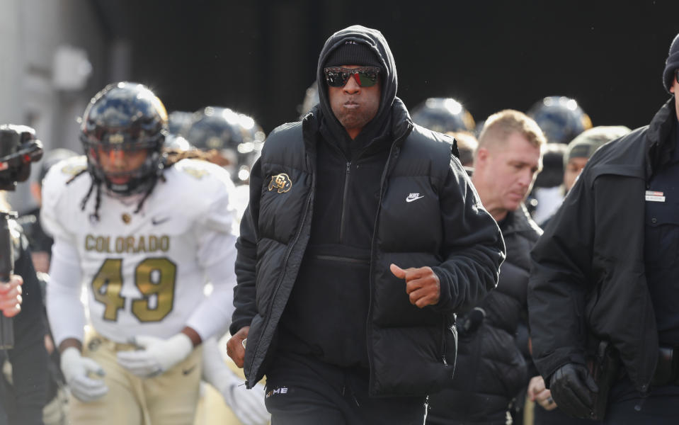 SALT LAKE CITY, UT – NOVEMBER 25: Colorado Buffaloes head coach Deion Sanders leads his team onto the field before the start of the game against the Utah Utes at Rice Eccles Stadium on November 25, 2023 in Salt Lake City, Utah. (Photo by Chris Gardner/Getty Images)