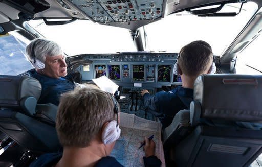 A handout photo provided by Sergey Dolya shows Russian Chief test pilot Alexander Yablontsev (L) in the cockpit of his Sukhoi Superjet 100 in Indonesia, on May 8. A Russian Sukhoi Superjet 100 with about 50 people on board went missing in a mountainous area south of the Indonesian capital Jakarta during a demonstration flight Wednesday, officials said