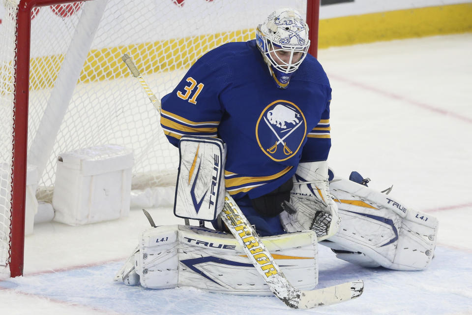 Buffalo Sabres goaltender Dustin Tokarski (31) makes a save during the third period of an NHL hockey game against the Montreal Canadiens on Friday, Nov. 26, 2021, in Buffalo, N.Y. (AP Photo/Joshua Bessex)