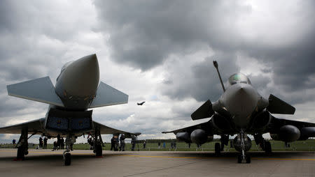 FILE PHOTO: Eurofighter Typhoon (L) and a Dassault Rafale are seen at the ILA Air Show in Berlin, Germany, April 26, 2018. REUTERS/Axel Schmidt/File Photo