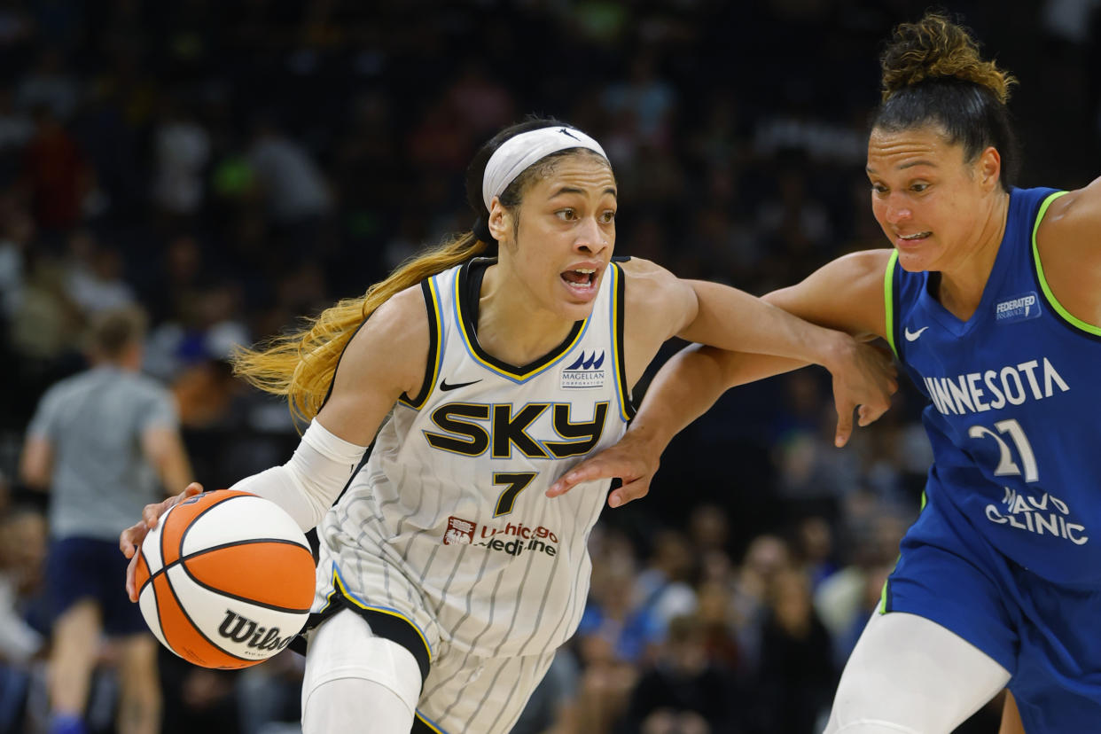 Chicago Sky guard Chennedy Carter (7) works around Minnesota Lynx guard Kayla McBride (21) in the third quarter of a WNBA basketball game Friday, Sept. 13, 2024, in Minneapolis. (AP Photo/Bruce Kluckhohn)