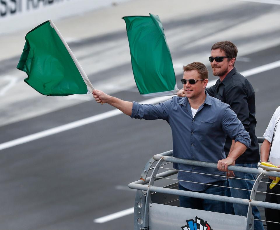 Actors Matt Damon and Christian Bale wave the green flags to start the103rd Indianapolis 500 at Indianapolis Motor Speedway on Sunday, May 26, 2019.