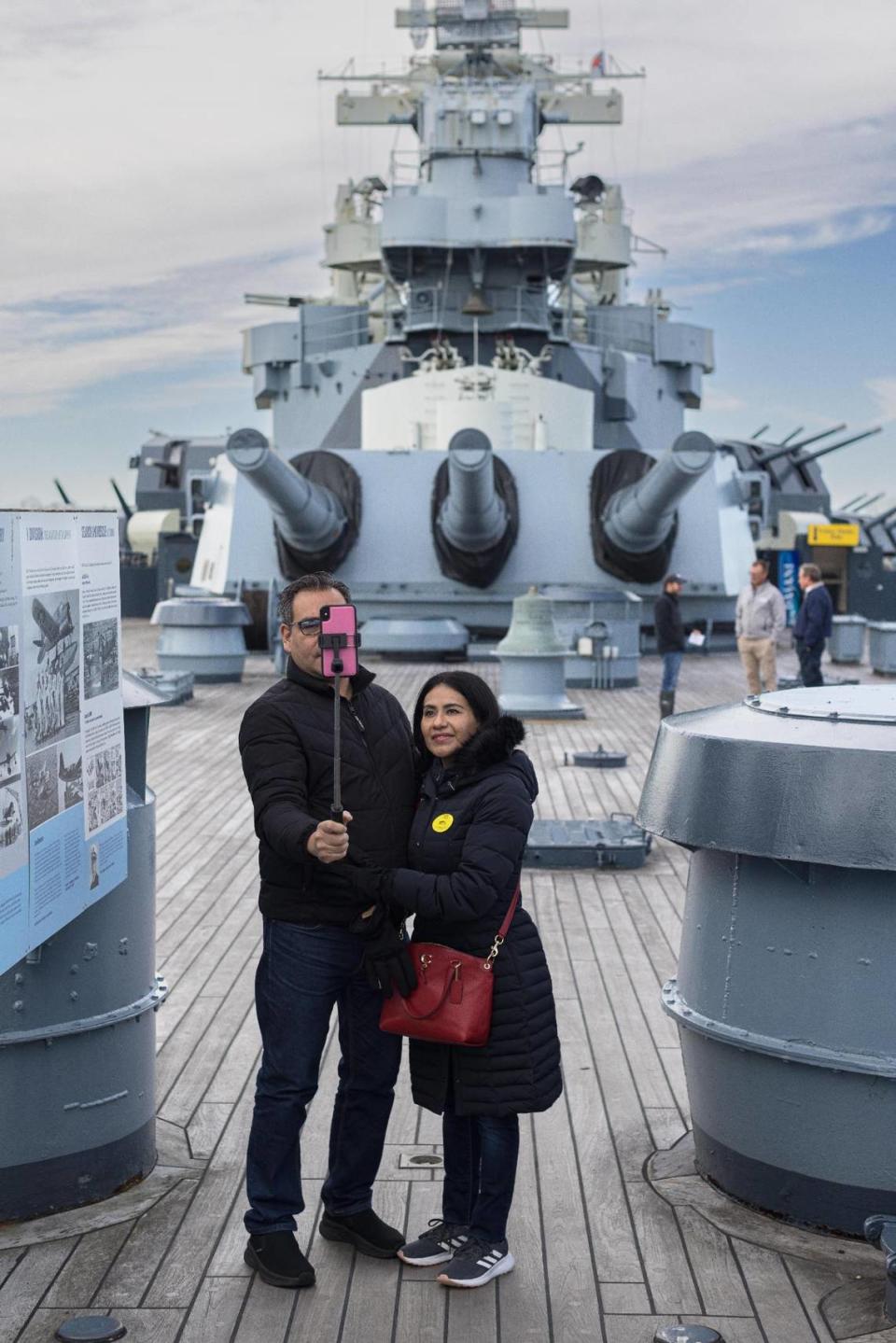 Miguel Mendoza and Iris Valerio take a selfie on the USS North Carolina in Wilmington on Nov. 28. MUST CREDIT: Justin Cook for The Washington Post