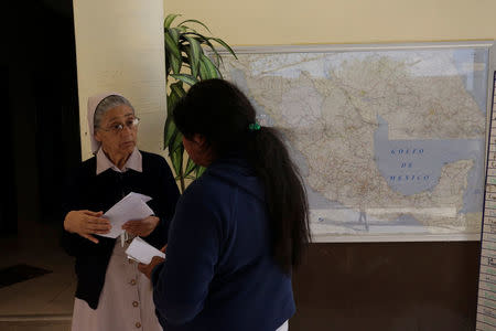 Sister Edith explains Mexican deportee Silvia how to take a bus back to his town in Oaxaca at Our Lady of Guadalupe migrant shelter in Reynosa, Mexico March 14, 2017. Picture taken March 14, 2017. REUTERS/Daniel Becerril