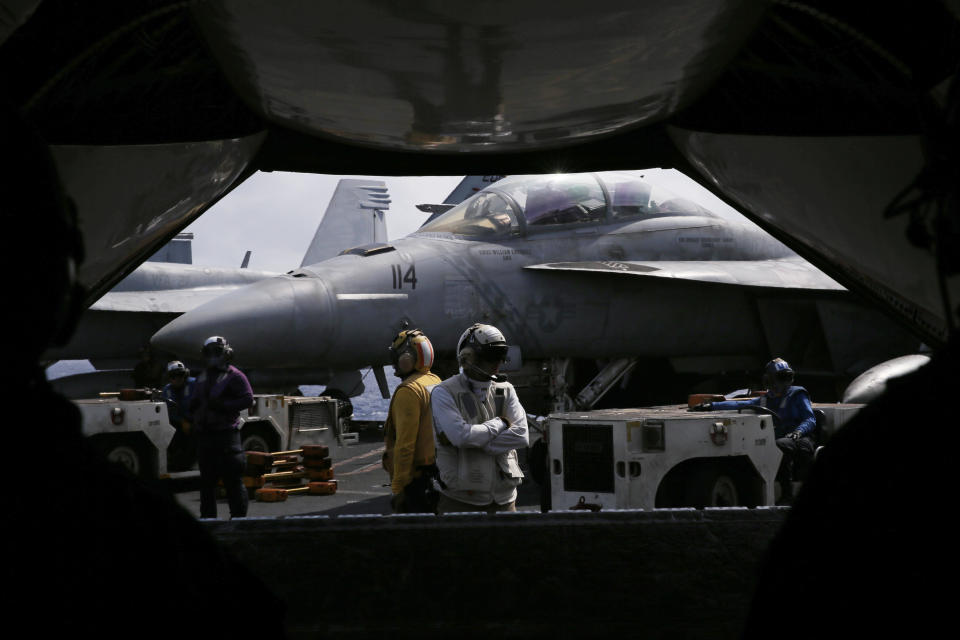 The F/A-18 Super Hornet fighter jets are seen on the deck of the U.S. Navy USS Ronald Reagan in the South China Sea, Tuesday, Nov. 20, 2018. China is allowing a U.S. Navy aircraft carrier and its battle group to make a port call in Hong Kong after it turned down similar request amid tensions with Washington. (AP Photo/Kin Cheung)