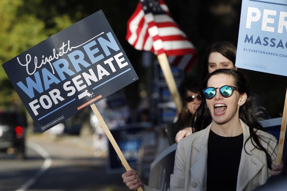 Katherine Swanson shows support for Sen. Elizabeth Warren before a debate with her opponent Geoff Diehl in Boston, Friday, Oct. 19, 2018. (AP Photo/Michael Dwyer)