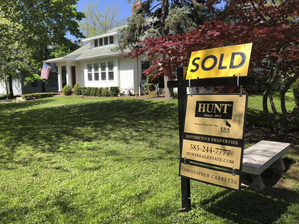 This May 22, 2020 photo shows a sold sign in front of a house in Brighton, N.Y. On Thursday, May 28, long-term U.S. mortgage rates fell this week as the key 30-year home loan marked an all-time low for the third time in the last few months since the coronavirus outbreak took hold. Mortgage buyer Freddie Mac reports that the average rate on the 30-year loan tumbled to 3.15% from 3.24% last week. (AP Photo/Ted Shaffrey)