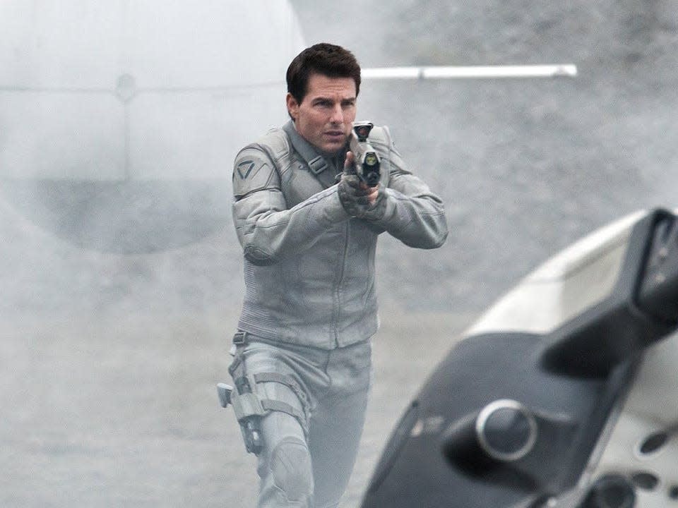 Tom Cruise in "Oblivion" holding up a gun