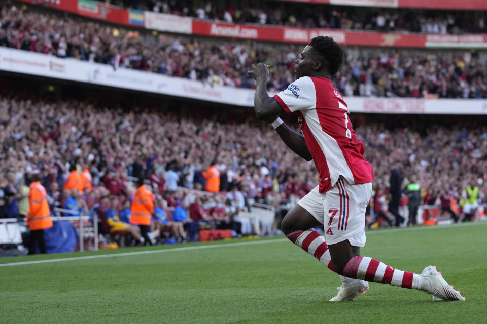 Arsenal's Bukayo Saka celebrates after scoring his side's third goal during the English Premier League soccer match between Arsenal and Tottenham Hotspur at the Emirates stadium in London, Sunday, Sept. 26, 2021. (AP Photo/Frank Augstein)