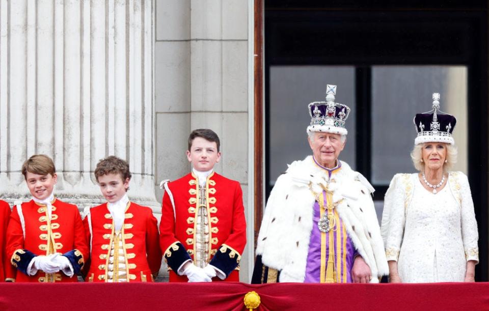 From left to right: Prince George, Oliver Cholmondeley, and Nicholas Barclay stand beside King Charles and Queen Camilla on the balcony of Buckingham Palace after their coronation in September 2022.