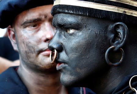 "The Savage", a white performer in a blackface disguise, takes part in the festival Ducasse d'Ath in Ath