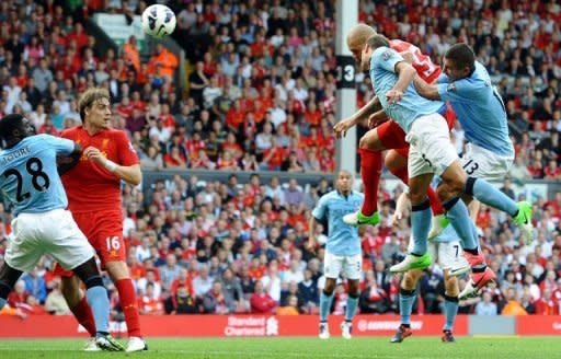 Liverpool's Slovakian defender Martin Skrtel (2nd R) scores from a header during the English Premier League football match between Liverpool and Manchester City at Anfield stadium in Liverpool. The match ended in a 2-2 draw
