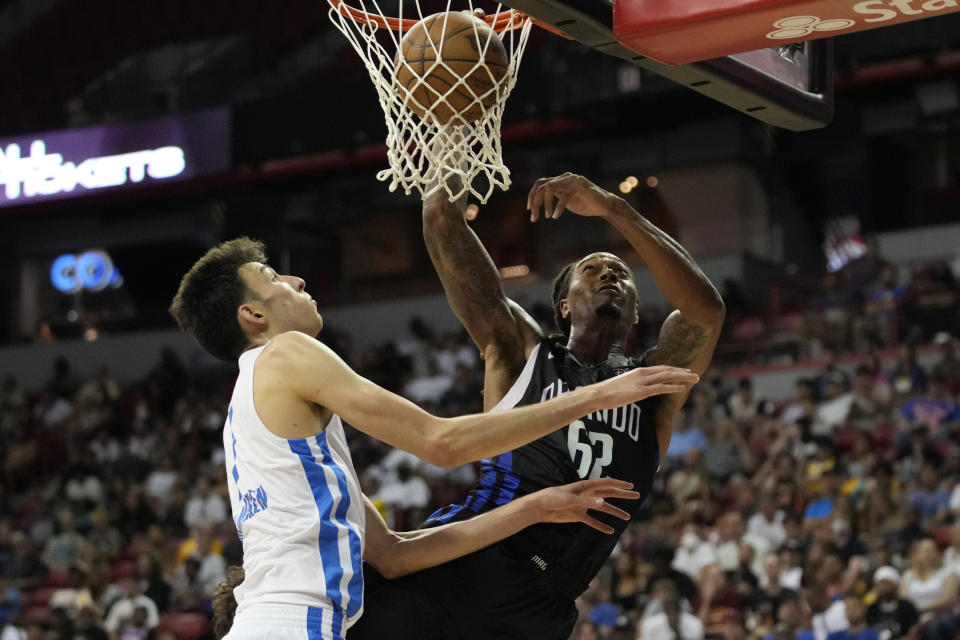 Orlando Magic's Emanuel Terry, right, dunks over Oklahoma City Thunder's Chet Holmgren during the second half an NBA summer league basketball game Monday, July 11, 2022, in Las Vegas. (AP Photo/John Locher)