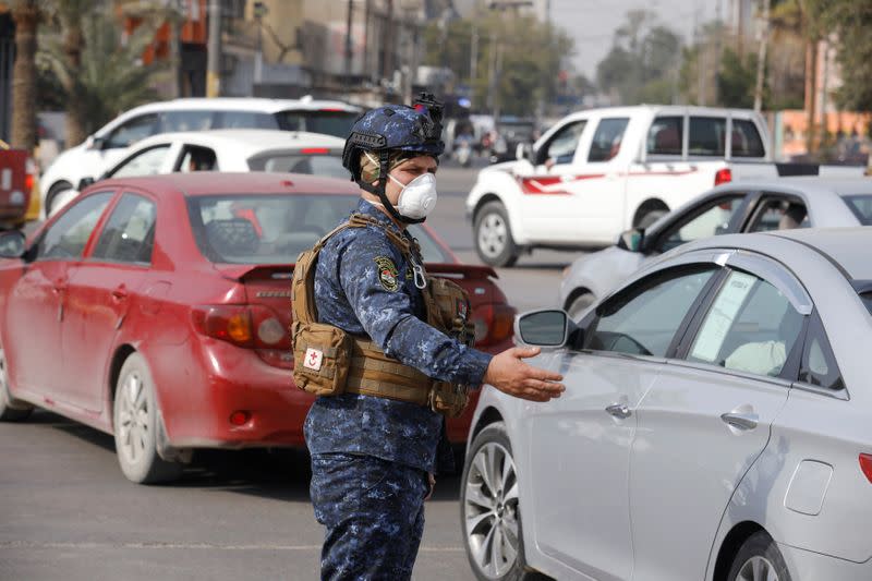 A member of the Iraqi security forces wears a protective face mask, following the coronavirus outbreak, in Baghdad