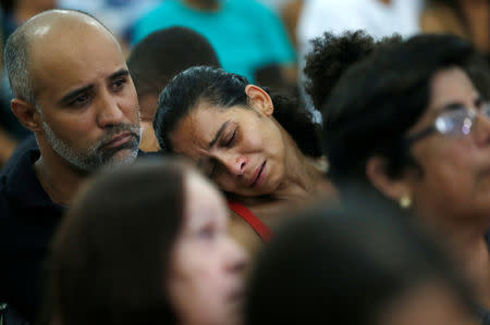 Relatives and friends of victims of a collapsed tailings dam owned by Brazilian mining company Vale SA, pay their respects during a mass in Brumadinho, Brazil January 31, 2019. REUTERS/Adriano Machado