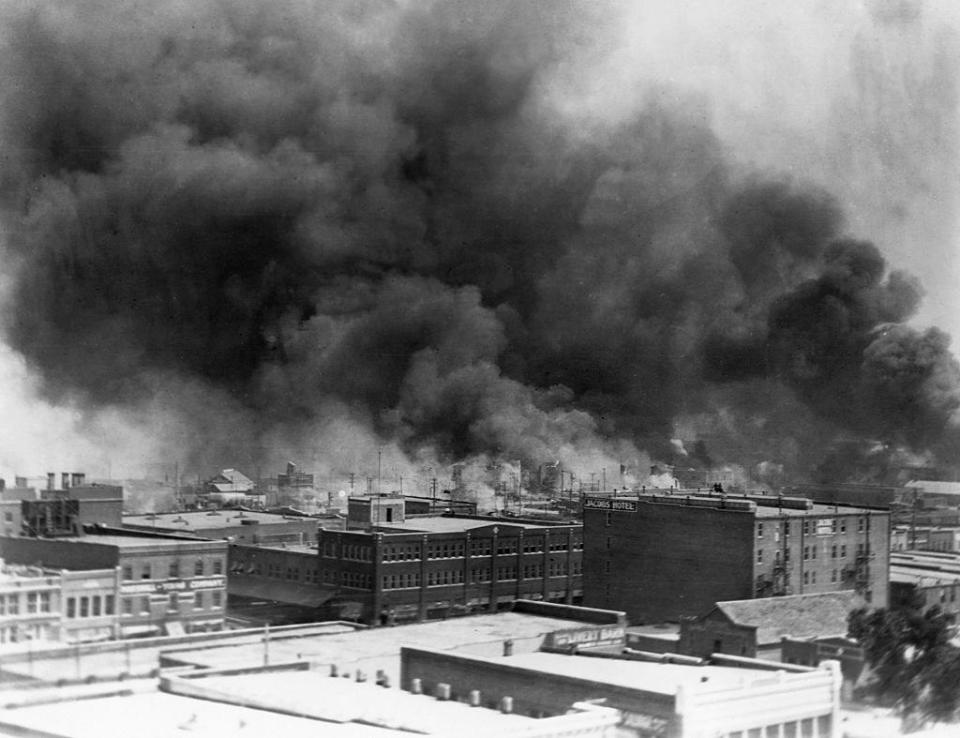 Black smoke billows from fires during the Tulsa Race Massacre of 1921,  in the Greenwood District, Tulsa, Oklahoma, US, June 1921.  / Credit: Corbis via Getty