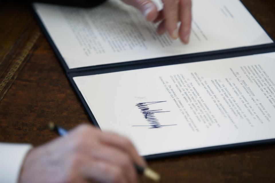 FILE - In this Jan. 24, 2017, file photo, the signature of President Donald Trump is seen on an executive order in Oval Office of the White House in Washington. Trump has taken 18 executive actions since being sworn into office on Jan. 20. Some of the papers he signed were executive orders that dealt with building the wall he promised along the U.S.-Mexico border; temporarily banning entry to the U.S. by refugees and people from seven majority-Muslim nations; and beginning to chip away at the Affordable Care Act. (AP Photo/Evan Vucci, File)