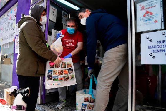 People get free food rations at a food bank in Madrid (AFP via Getty Images)