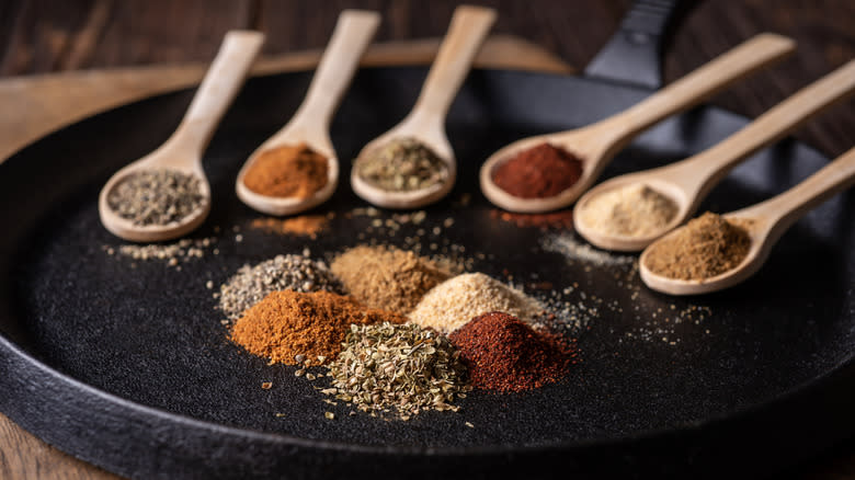 spices in piles and on spoons
