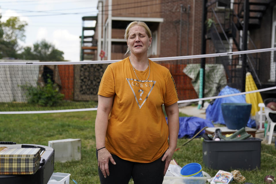 Kristen Bigogno cries as she stands amongst her belongings while being evicted from her home Friday, Sept. 17, 2021, in St. Louis. Bigogno is among thousands of Americans facing eviction now that the national moratorium has ended. (AP Photo/Jeff Roberson)