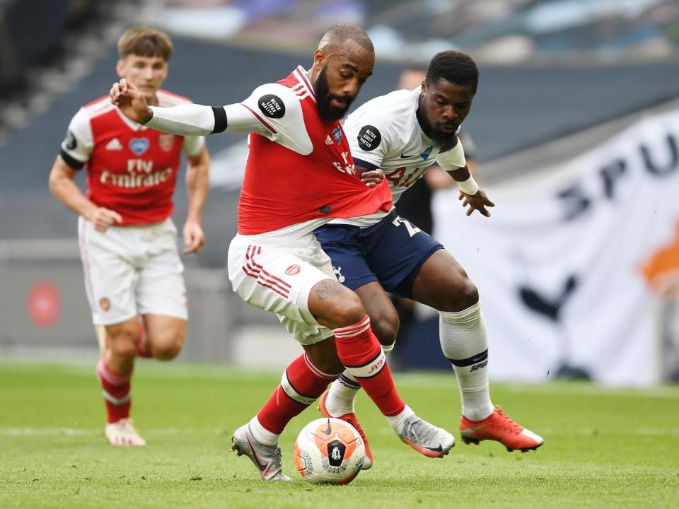 Alexandre Lacazette tries to hold off Serge Aurier: Getty