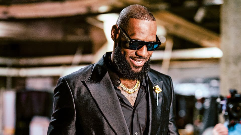 Pictured above, a sharply suited LeBron James arrives for a Los Angeles Lakers game against the Oklahoma City Thunder on February 7, 2023. - Tyler Ross/NBAE/Getty Images/Courtesy Workman