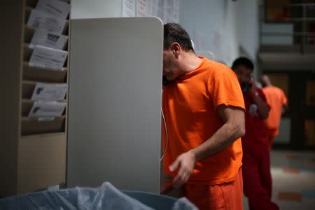 ICE detainees make phone calls at the Adelanto immigration detention center, which is run by the Geo Group Inc (GEO.N), in Adelanto, California, U.S., April 13, 2017. REUTERS/Lucy Nicholson