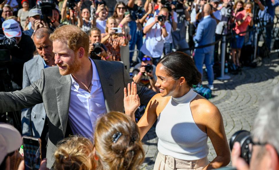 Prince Harry and Duchess Meghan of Sussex leave city hall in Duesseldorf, Germany, where they kicked off the "One Year to Go" campaign for the Invictus Games Duesseldorf 2023, on Sept. 6, 2022.