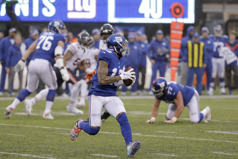 New York Giants wide receiver Odell Beckham prepares to launch a touchdown pass to wide receiver Russell Shepard, not pictured, during the second half of an NFL football game, Sunday, Dec. 2, 2018, in East Rutherford, N.J. (AP Photo/Seth Wenig)