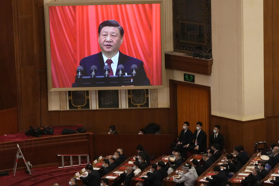 Chinese President Xi Jinping is displayed on a screen as he delivers a speech at the closing ceremony for China's National People's Congress (NPC) at the Great Hall of the People in Beijing, Monday, March 13, 2023. (AP Photo/Andy Wong)