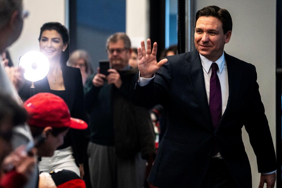 Republican presidential candidate Ron DeSantis waves as he enters a campaign stop at Elevate Business and Events Center on Friday, Dec. 8, 2023, in West Des Moines.