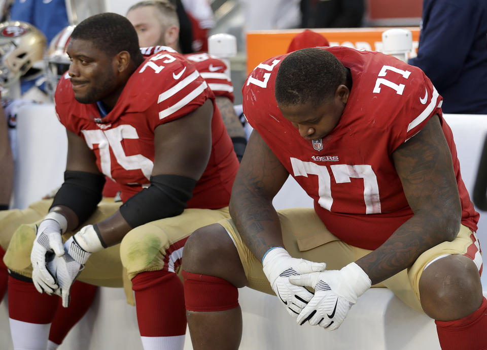 49ers guard Laken Tomlinson (75) and tackle Trent Brown (77) sit on the bench as the team fell to 0-9. (AP)