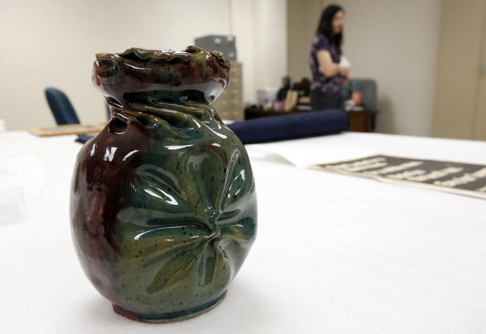 In this Oct. 11, 2013 photograph, this early 1900's pinch pot made by American ceramic artist and the self-proclaimed "Mad Potter of Biloxi," George Ohr, will eventually be displayed in the state history museum in Jackson, Miss. Officials say they did not set out to have separate-but-equal museums for the documentation of the state's history, but it could end up that way. Mississippi breaks ground Thursday. Oct. 24, 2013, on side-by-side museums that are expected to break ground of their own in how they depict the Southern state once rocked by racial turmoil. (AP Photo/Rogelio V. Solis)