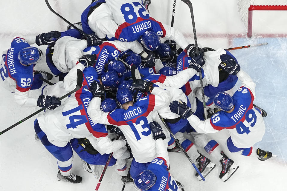 Slovakia players celebrate after beating the United States 3-2 in a shoot-out in a men's quarterfinal hockey game at the 2022 Winter Olympics, Wednesday, Feb. 16, 2022, in Beijing. (AP Photo/Matt Slocum)