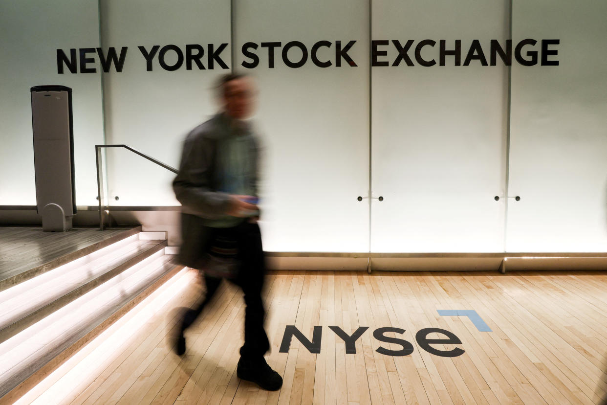 FTSE  A trader walks on the trading floor of the New York Stock Exchange (NYSE) in New York City, U.S., March 23, 2023.  REUTERS/Brendan McDermid