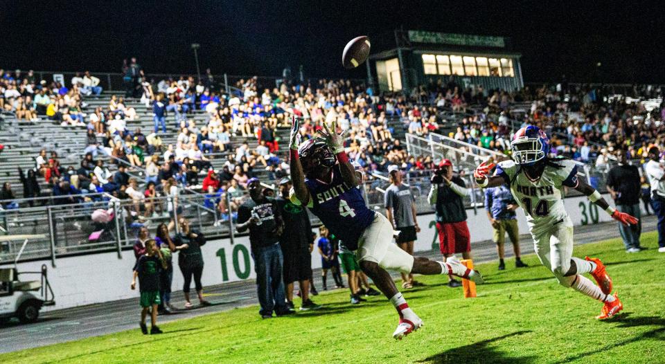 South’s Jerry Cooper hauls in a touchdown pass in front of North’s Leon Thomas during the The 33rd annual Rotary South All-Star Game at Fort Myers High on Wednesday, Dec. 8, 2021. 