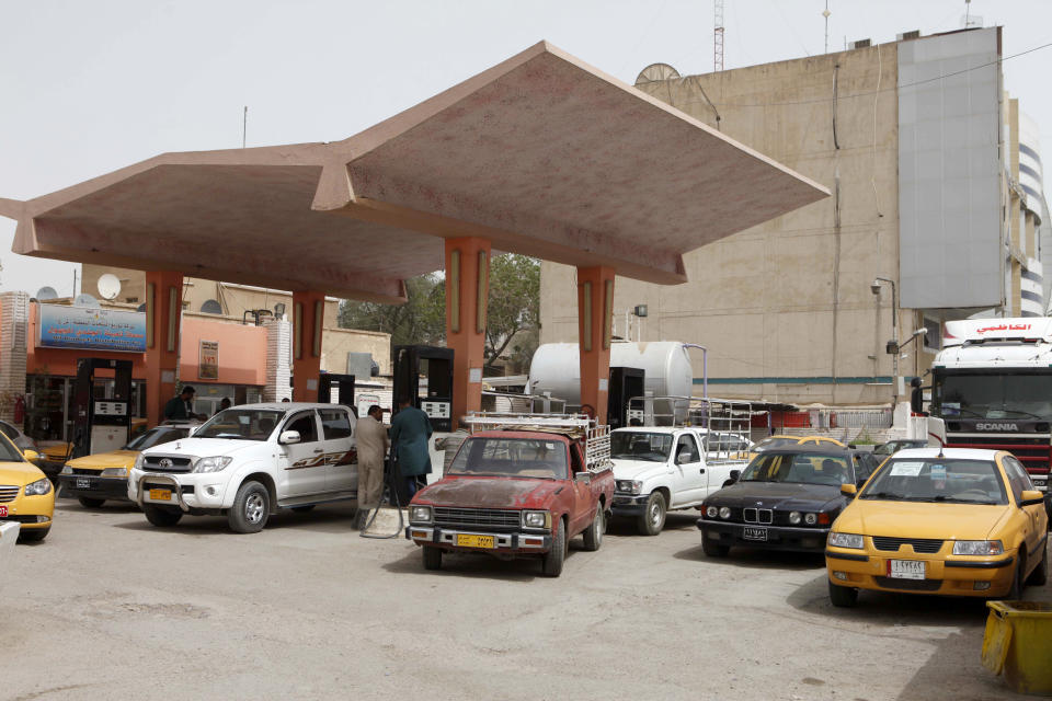 In this Wednesday, Aug. 15, 2012 photo, Iraqis fill up at a gas station in Baghdad, Iraq. Iraq is fast becoming an oil producing powerhouse, but many Iraqis see little reason to celebrate the postwar petroleum gains that have turned Iraq into a leading oil producer. (AP Photo/Karim Kadim)