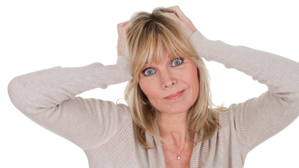 A woman scratching her itchy scalp