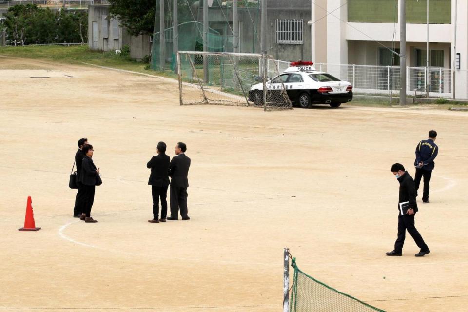 Officials examine the school's playground