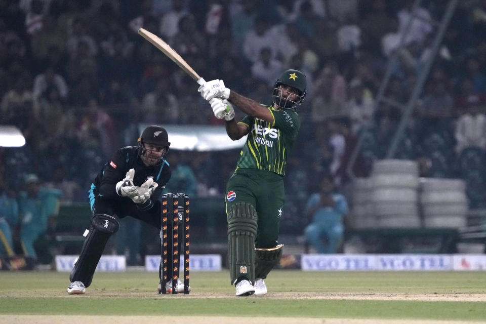 Pakistan's Fakhar Zaman, center, plays a shot as New Zealand's Tom Blundell watches during the fourth T20 international cricket match between Pakistan and New Zealand, in Lahore, Pakistan, Thursday, April 25, 2024. (AP Photo/K.M. Chaudary)