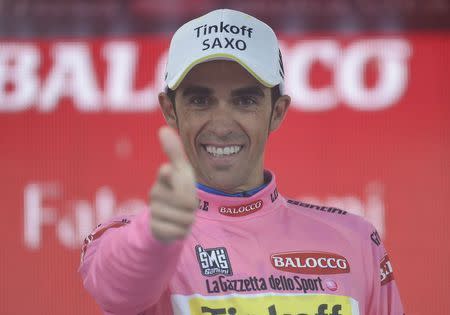 Tinkoff Saxo rider Alberto Contador of Spain celebrates retaining the leader's pink jersey on the podium after the 190 Km (118 miles) twelfth stage of the 98th Giro d'Italia (Tour of Italy) cycling race from Imola to Vicenza, Italy, May 21, 2015. REUTERS/LaPresse/Fabio Ferrari