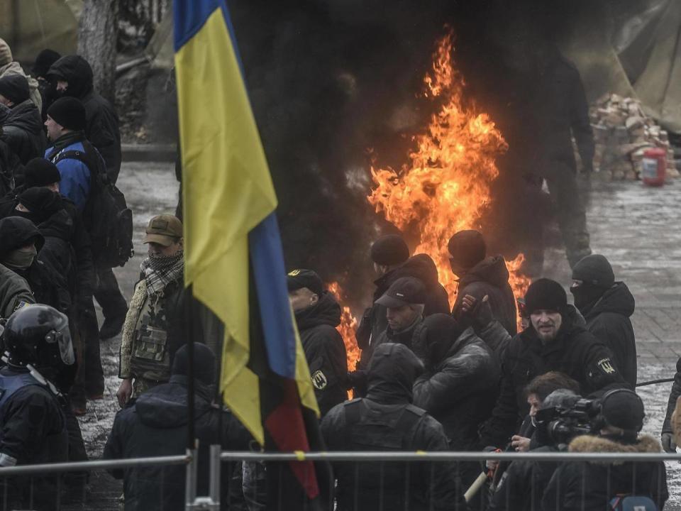 Protesters clash with police during their rally in front of the Parliament building in Kiev (EPA)